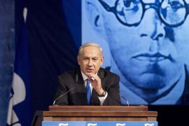 Israeli Prime Minister Benjamin Netanyahu delivers a speech during a meeting of his Likud party in Tel Aviv on May 6, 2012. Netanyahu called for early elections, suggesting he would seek a September vote instead of waiting until the scheduled October 2013 date. Picture shows late Zionist leader Zeev Jabotinsky. AFP PHOTO / JACK GUEZ