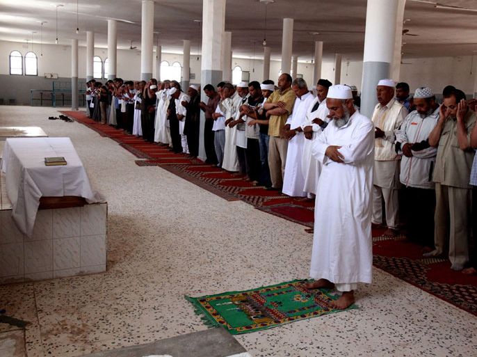 LIBYAN ARAB JAMAHIRIYA : Friends and relatives pray over body of Abdelbaset Ali Mohmet al-Megrahi, the only person convicted over the 1988 Lockerbie bombing which killed 270 people, during his funeral on May 21, 2012 in Janzur, a suburb West of the Libyan capital. Megrahi, who always maintained his innocence, died on May 20, almost three years after the Scottish government freed him on compassionate grounds following his diagnosis with prostate cancer. AFP PHOTO/MAHMUD TURKIA