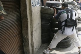 BEI - Tripoli, -, LEBANON : a Sunni Muslim gunman takes position along Syria Street in the Bab al-Tabbaneh neighbourhood during clashes with Alawites, an offshoot of Shiite Islam to which Syrian President Bashar al-Assad belongs, in the Jabal Mohsen neighbourhood in the northern Lebanese port city of Tripoli on May 14, 2012