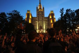 Opposition activists rally during an anti-Putin 'occupy' sit-in protest at their new camp under a famous Stalin-era skyscraper in Moscow, late on May 17, 2012. Russians unhappy with Vladimir Putin's presidential return after a four-year stint as prime minister have been increasingly turning to creative forms of protest that slip through legal loopholes and do not require formal city sanction. AFP