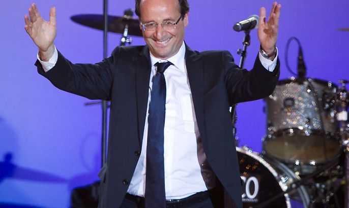 French Socialist Party (PS) presidential candidate Francois Hollande celebrates on stage after winning the second round of the French presidential elections, on Place de la Bastille, in Paris, France, 06 May 2012. French Socialist candidate Francois Hollande defeated incumbent Nicolas Sarkozy in the final round of France's presidential election, with exit polls indicating that Hollande is leading with approximately 52 per cent of the vote. EPA/IAN LANGSDON