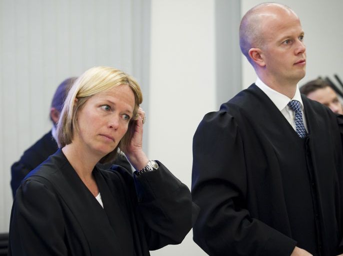 Public prosecutors Svein Holden (R) and Inga Bejer Engh stand as Anders Behring Breivik, who killed 77 people in twin attacks in Norway , arrives in the courtroom in Oslo on May 7, 2012.