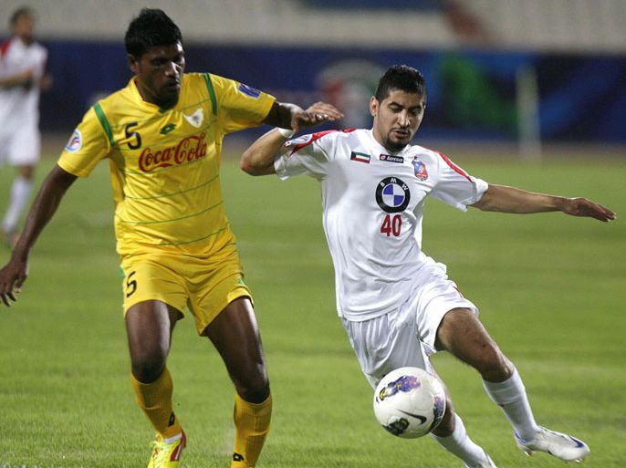 Kuwait SC player Abdulhadi Khamees (R) vies for the ball with Maldives' VB Addu SC player Jambe Jameel during their Group C, AFC Cup football match in Kuwait City on May 8, 2012. AFP PHOTO / YASSER AL-ZAYYAT