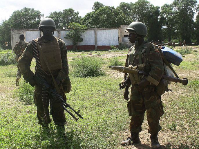 Soldiers of the African Union Mission in Somalia (AMISOM) patrol at a farm in Afgoye district, southeastern Shabelle region, on May 27, 2012, after ousting Al Shebab fighters during a joint operation with Somali military forces. Al-Qaeda-linked Somali militants vow to intensify the war against government and African Union troops, despite the fall of their key stronghold of Afgoye