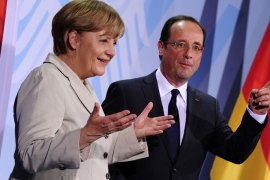 German Chancellor Angela Merkel (L) and the new French president Francois Hollande gesture after addressing a press conference at the German Chancellery on May 15, 2012 in Berlin.
