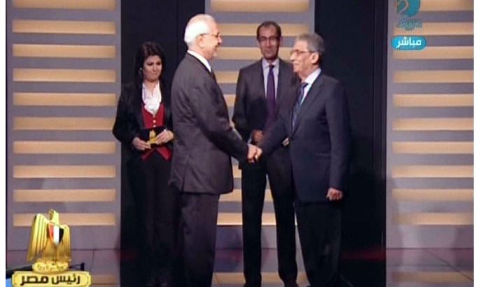 An image grab taken from the private Egyptian Dream TV channel shows hopeful presidential candidates, the moderate Islamist, Abdelmoneim Abul Fotouh (L) and former Arab League General Secretary, Amr Mussa (R) shaking hands as they attend their live debate in Cairo on May 10, 2012. Egypt is set to hold its first ever debate between presidential candidates on Thursday when two frontrunners for this month's election duel it out on television. AFP