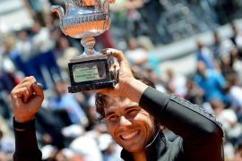 epa03228712 Spanish tennis player Rafael Nadal poses with the winner's trophy after beating Serbian tennis player Novak Djokovic in their final match of the Italian Open tennis tournament in the Central Stadium at the Foro Italico in Rome, Italy, 21 May 2012. EPA/CLAUDIO ONORATI