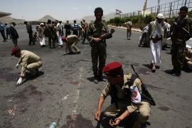 Yemeni military police collect evidence at the site of a suicide bomb attack in Sanaa on May 21, 2012. A Yemeni soldier packing powerful explosives under his uniform blew himself up in the middle of an army battalion the Yemeni capital, killing 96 troops and wounding around 300, a military official and medics said.