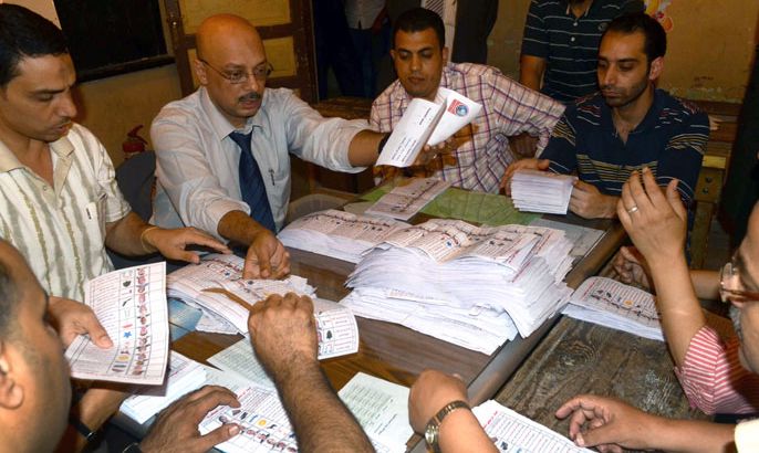 Egyptian election officials count ballot papers at a polling station in Alexandria on May 24, 2012 after polls closed in country's landmark presidential election. Around 50 million eligible voters were called to cast their ballots in 13,000 polling stations around the country. AFP PHOTO/MARCO LONGARI