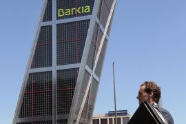 A man walks in front of the Bankia headquarters, formerly the CajaMadrid headquarters, in Madrid, Spain, 15 July 2011. Bankia is a Spanish banking conglomerate which was established on 03 December 2010 as a result of the merger of seven regional Spanish savings banks. EPA/LEONARDO WEN