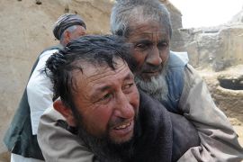 In this photograph taken on May 8, 2012 Afghan men rescue an elderly man after a flood in Dah Mard village of Sangcharak district in Sar-e Pul province. At least 26 people were killed and more than 100 missing after flash floods hit a wedding party and three villages in northern Afghanistan, an official said on May 7. Most of the victims were women and children as the floods, caused by heavy rains, swept through areas of Deh Mardan district in Sari Pul province, said Fazlullah Sadat, head of the provincial disaster management authority. AFP PHOTO/ Qais Usyan