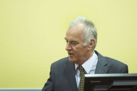The Hague, -, NETHERLANDS : Former Bosnian Serb army chief Ratko Mladic (R) sits on May 16, 2012 at the International Criminal Tribunal for the former Yugoslavia (ICTY) in The Hague before the opening of his war crimes trial. Mladic faces 11 counts including genocide, war crimes, and crimes against humanity for his role in the Bosnian war, in particular the 1995 Srebrenica massacre