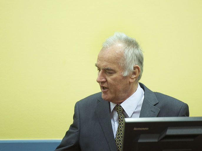 The Hague, -, NETHERLANDS : Former Bosnian Serb army chief Ratko Mladic (R) sits on May 16, 2012 at the International Criminal Tribunal for the former Yugoslavia (ICTY) in The Hague before the opening of his war crimes trial. Mladic faces 11 counts including genocide, war crimes, and crimes against humanity for his role in the Bosnian war, in particular the 1995 Srebrenica massacre