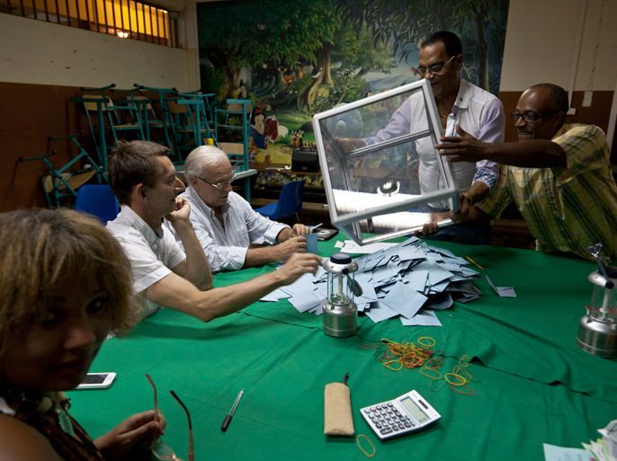 Remire-Montjoly, -, FRANCE (GUIANA) : Scrutineers prepare to count the ballots at a polling station, on May 6, 2012, in Remire-Montjoly, French Guiana, after the vote for the second round of the French presidential election. France goes to the polls to give its final verdict in the tense presidential battle between incumbent President and UMP right-wing ruling party candidate Nicolas Sarkozy and his Socialist challenger Francois Hollande. AFP PHOTO JODY AMIET