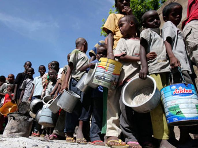 Internally displaced children queue to collect food relief from the World Food Programme (WFP) at a settlement in the capital Mogadishu August 7, 2011. The United Nations says about 3.6 million people are now at risk of starvation in Somalia and about 12 million people across the Horn of Africa region, including in Ethiopia and Kenya. This famine has occurred due to drought, conflict and a lack of food aid.