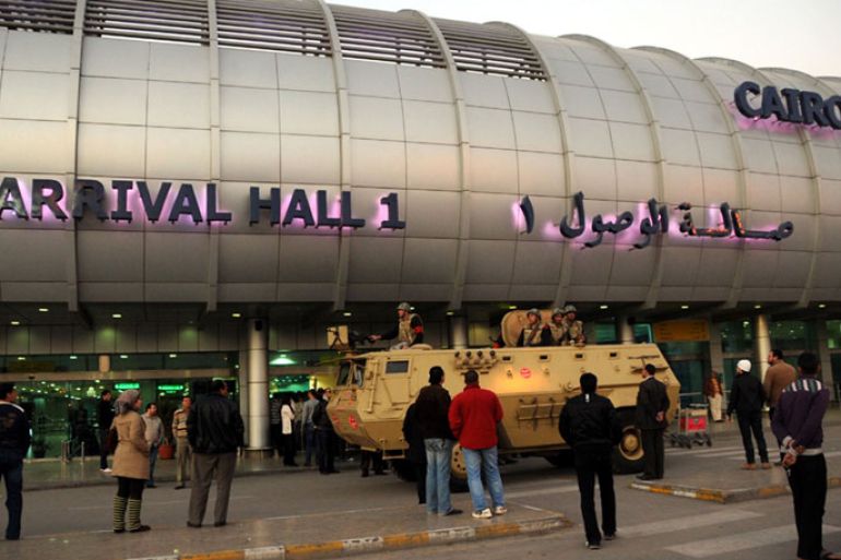 epa03097617 A handout photograph made available by the Middle East News Agency (MENA) on 09 February 2012, shows an army armored vehicle stationed at Cairo International Airport, in Cairo, Egypt, 08 February 2011. Egypt's military-backed government has deployed troops countrywide, as the opposition calls for civil disobedience to press for a transfer of power to an elected administration. Armored vehicles were deployed outside key state institutions, including Cairo airport. More than 30 protest groups are supporting the civil disobedience campaign due to start on 11 February, the first anniversary of Hosni Mubarak's ousting as president. EPA/MENA/HANDOUT HANDOUT EDITORIAL USE ONLY/NO SALES