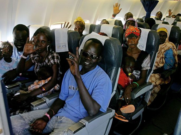 Ethnic South Sudanese board a plane to fly home at Sudan's Khartoum airport on May 14, 2012 as an airlift of up to 15,000 South Sudanese began. The first plane chartered by the International Organisation for Migration (IOM) in the early morning carried around 160 South Sudanese