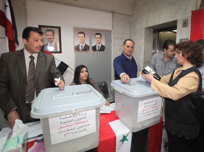 A Syrian woman casts her vote at a polling station in Damascus, Syria, as Syrians across the country began voting on 07 May 2012 in parliamentary elections. Polls opened amid tight security and ongoing unrest in some parts of the country. State television showed voters queueing at polling station since early morning. The election initially scheduled for September was postponed due to the uprising against President Bashar al-Assad. The UN estimates that 9,000 people have died in the unrest since March 2011. A total of 7,195 candidates including 710 women registered to contest the 250 seats, according to state news agency SANA. EPA/YOUSSEF BADAWI