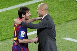 Barcelona's Argentinian forward Lionel Messi (L) celebrates with Barcelona's coach Josep Guardiola after scoring a goal during the Spanish league football match FC Barcelona vs RCD Espanyol on May 5, 2012 at the Camp Nou stadium in Barcelona. AFP PHOTO/ JOSEP LAGO