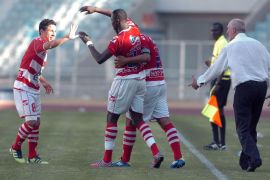 Tunisian Club Africain players congratulate their teammate Ndouasel Ezechiel (C) after he scored against Swaziland Royal Leopards FC during the CAF Confederation Cup football match at the Rades Olympic stadium near Tunis on May 12, 2012. Club Africain won 4-2. AFP PHOTO / FETHI BELAID