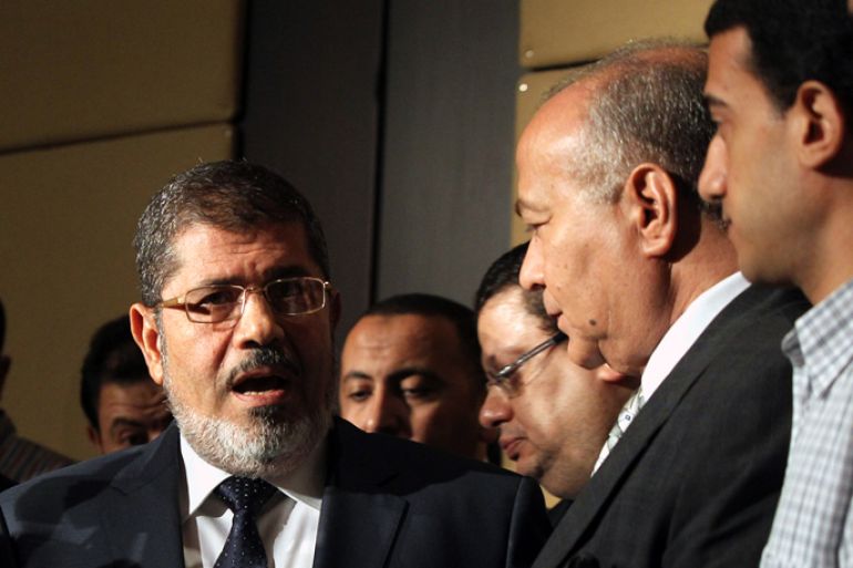 epa03277391 Egyptian Presidential candidate Mohamed Morsi (L) is seen before his press conference in Cairo, Egypt, 22 June 2012. Morsi, the Muslim Brotherhood's presidential candidate, on 22 June criticized Egypt's military rulers for granting themselves sweeping powers in an interim constitution and dissolving the lower house of parliament. He also warned against "tampering" with the result of last week's presidential elections, which pitted him against Ahmed Shafiq, an ex-military general. EPA
