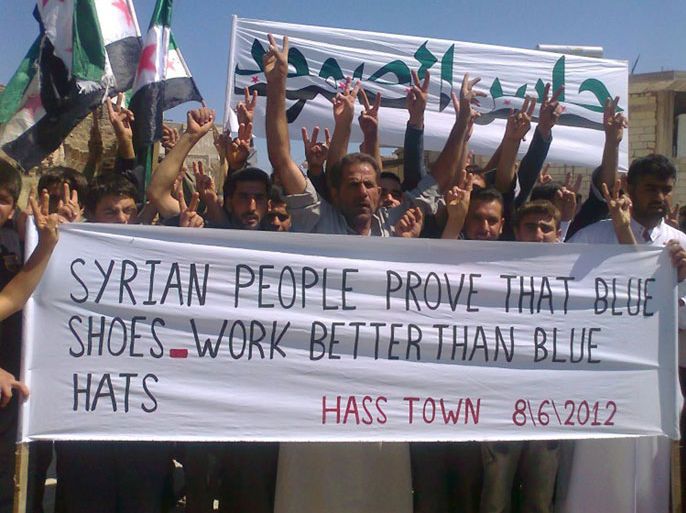 A handout image released by the Syrian opposition's Shaam News Network shows Syrians flashing the victory sign during an anti-regime demonstration in Hass in the restive northern province of Idlib on June 8, 2012