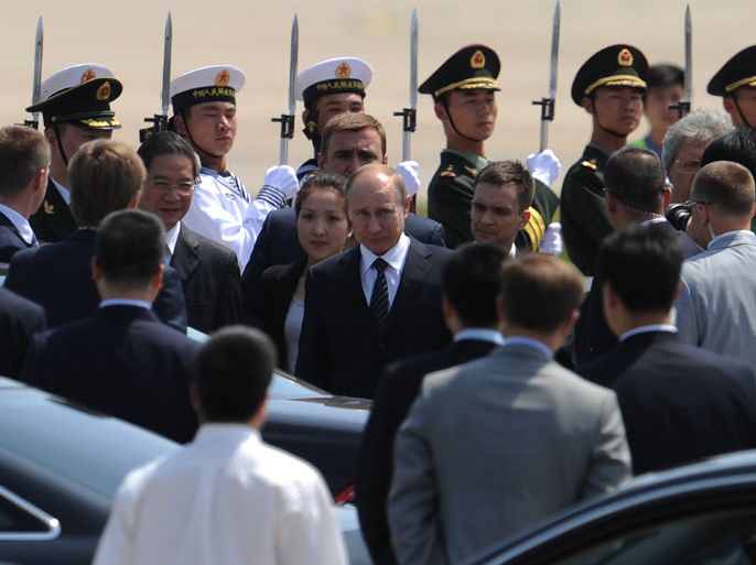 Russian President Vladimir Putin (C) walks to his car upon his arrival at the Beijing International Airport on June 5, 2012. Putin arrived in China on June 5 for a three-day visit aimed at bolstering a crucial alliance. AFP PHOTO / LIU JIN