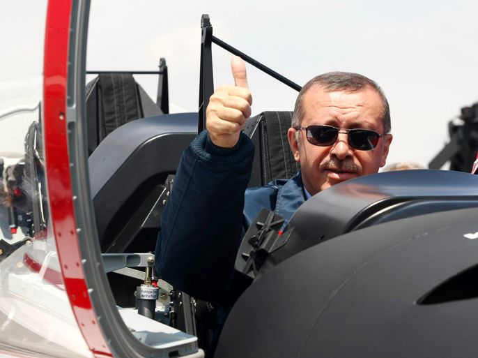 TOPSHOTS  Turkish Prime Minister Recep Tayyip Erdogan gives a thumbs-up sign from the cockpit of the Turkish Primary and Basic Trainer Aircraft "Hurkus" during a ceremony at the Turkish Aerospace Industries in Ankara June 27, 2012.  AFP