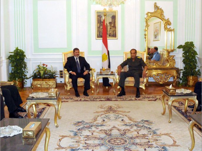 In a handout picture released by the Egyptian military press office in Cairo, Egypt's military council chief Field Marshal Hussein Tantawi (C-R) meets with president-elect Mohamed Morsi (C-L) in the Egyptian capital on June 25, 2012. Morsi, who defeated his rival, ex-Mubarak premier Ahmed Shafiq, with 51.7 percent of the presidential election vote, quickly moved to allay domestic and international concerns over the Islamists' victory in the Arab world's most populous country.