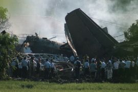 Emergency personnel look through the rubble after an Indonesian military aircraft crashed in Jakarta on June 21, 2012