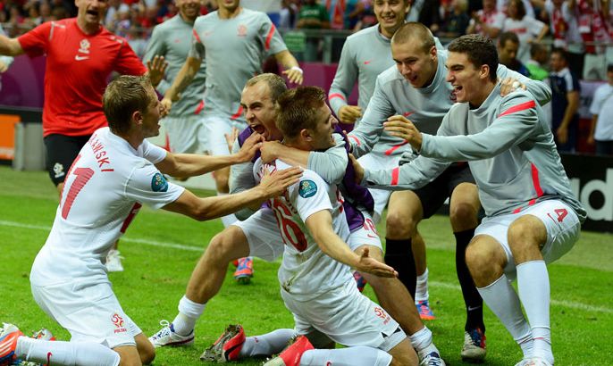 WARSAW, POLAND - JUNE 12: Jakub Blaszczykowski of Poland celebrates scoring their first goal with his team mates during the UEFA EURO 2012 group A match between Poland and Russia at The National Stadium on June 12, 2012 in Warsaw, Poland. (Photo by Shaun Botterill/Getty Images)