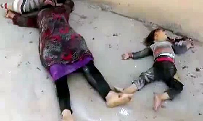 An image grab taken from a video uploaded on YouTube on June 21, 2012 allegedly shows the body of a Syrian woman and child killed by government forces during recent violence in the village of Kfar Takharim, in Idlib province. Clashes in Syria on June 21