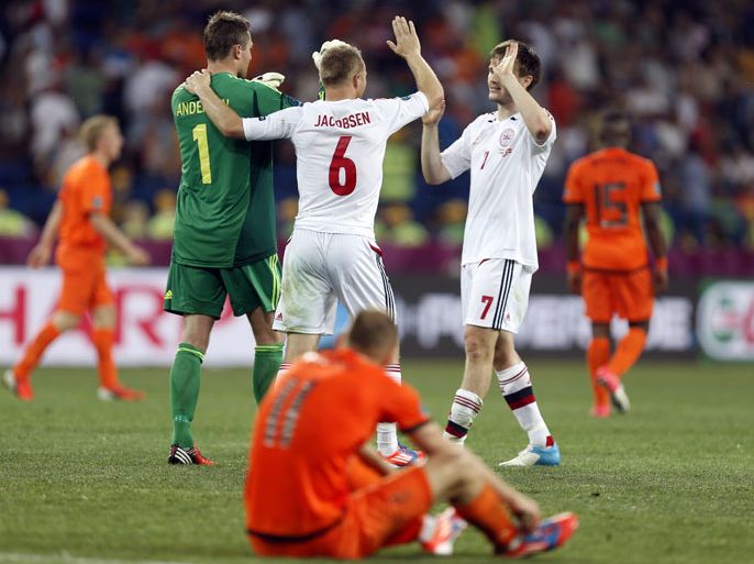 epa03256911 Danish players celebrate as Dutch Arjen Robben (front) shows his dejection after the Group B preliminary round match of the UEFA EURO 2012 soccer championship between Netherlands and Denmark in Kharkiv, Ukraine, 09 June 2012. Denmark won 1-0. EPA/TOLGA BOZOGLU UEFA Terms and Conditions apply http //www.epa.eu/downloads/UEFA-EURO2012-TCS.pdf