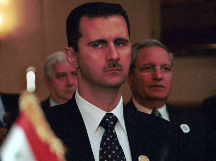 : Syrian President Bashar Al Assad, center, and Syrian Foreign Minister Farouk Al Sharaa, right, attend the Arab Summit March 27, 2001 in Amman, Jordan. The primary agenda for the first regular Arab summit to be held in 10 years is to reach consensus on the international isolation of Iraq and a unified stance on the Israeli-Palestinian conflict. (Courtney Kealy/Newsmakers)
