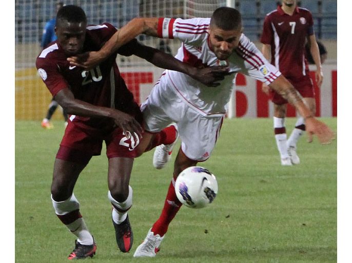 Lebanon's national team player Youssef Mohamad (R) vies for the ball against Qatar's national team player Yusef Ahmed Ali (L) during their 2014 World Cup Asian qualifying football match in Beirut on June 3, 2012. AFP PHOTO / ANWAR AMRO