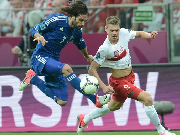 Greek forward Giorgios Samaras (L) vies during the Euro 2012 championships football match Poland vs Greece on June 8, 2012 at the National Stadium in Warsaw. The game ended in a draw 1-1. AFP PHOTO/ ARIS MESSINIS