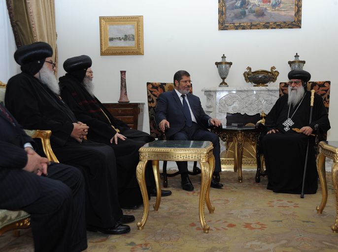 In this handout picture made available by the Egyptian presidency, Egypt's president-elect Mohamed Morsi meets with a Christian delegation headed by the caretaker pope of the country's Coptic Church, Bishop Pachomius (R), at the presidential palace in Cairo on June 26, 2012. The bishop, who was appointed interim head of the church and spiritual representative of roughly 10 million Copts after Pope Shenouda's death in March, had congratulated the Islamist leader on winning the country's presidential poll following the announcement of the election results on the weekend. AFP