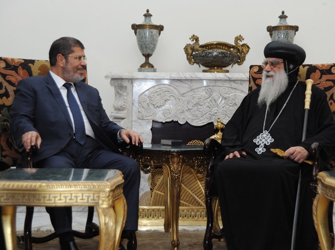 In this handout picture made available by the Egyptian presidency, Egypt's president-elect Mohamed Morsi meets with the caretaker pope of the country's Coptic Church, Bishop Pachomius, at the presidential palace in Cairo on June 26, 2012. The bishop, who was appointed interim head of the church and spiritual representative of roughly 10 million Copts after Pope Shenouda's death in March, had congratulated the Islamist leader on winning the country's presidential poll following the announcement of the election results on the weekend. AFP