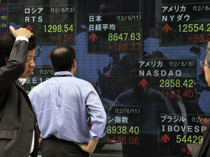 epa03259191 Businessmen check Tokyo's Nikkei stock average (center on top) during an afternoon trading session in Tokyo, Japan, 11 June 2012. Japan's Nikkei stock average rose 165.64 points to 8,624.90 at the close of Tokyo market after euro zone countries agreed to offer 100 billion euros to help Spain's bank crisis. Firegures are (clockwise from left);Russia's RTS, Japan's Nikkei average, New York Dow index, NASDAQ, Sao Paulo's stock average and Mumbai's stock average. EPA/KIMIMASA MAYAMA