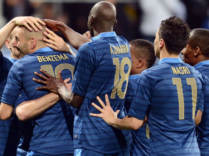 French forward Karim Benzema (L) celebrates with teammates after scoring a goal during the friendly football match France vs Estonia on June 5, 2012, at the Le Mans Stadium in Le Mans, western France. AFP PHOTO / FRANCK FIFE