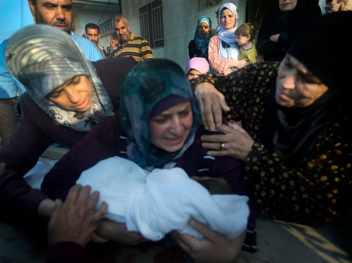 The mother of 5 year-old Yazan Gassan Rezk holds his body during his funeral on June 21, 2012, after he was killed by a sniper at a checkpoint in Qusayr, outside the flashpoint Syrian city of Homs. AFP PHOTO/STR