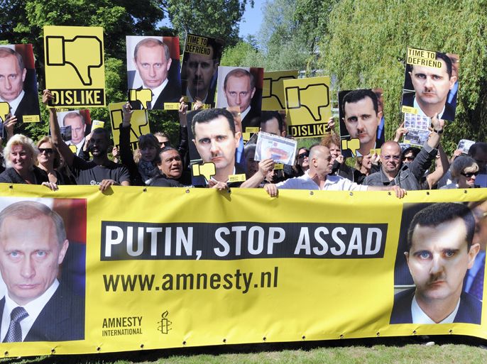 epa03264333 Amnesty International activists are seen during a demonstration for Syria at the Russian embassy in The Hague, the Netherlands, 14 June 2012. The goal of the demonstration is to raise up the international pressure on the Russian President Vladimir Putin to stop the human right violations in Syria. EPA