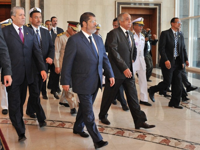 In this handout picture made available by the Egyptian presidency, Egypt's new president-elect Mohamed Morsi (front-L) walks with Interior Minister Mohammed Ibrahim Yusef (C) during their meeting in Cairo on June 26, 2012. Egypt's first civilian president, and its first elected leader since an uprising ousted president Hosni Mubarak early last year, pushed ahead with selecting a government of mostly technocrats amid delicate negotiations with the ruling military on its future powers, aides said. AFP