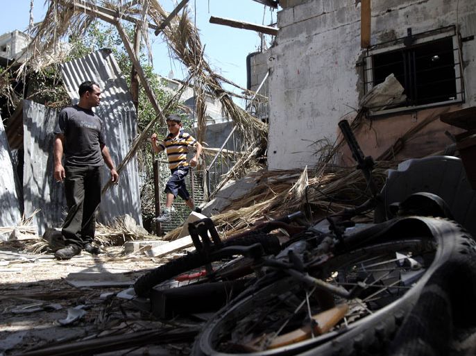 Palestinians inspect damages in the Nusseirat refugee camp in the central Gaza Strip following Israeli air strikes on June 3, 2012. Several Palestinians were wounded in a series of Israeli strikes on the Gaza Strip, two days after fire exchanges that left three dead from both sides