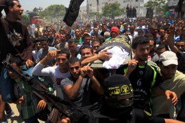 : Palestinian mourners carry the body of one of the two Palestinians who were killed in an Israeli air strike on north Gaza during their funeral on June 18, 2012. Witnesses identified the two men as members of the radical Islamic Jihad movement and said they were riding a motorcycle near the Israeli border at the time. AFP PHOTO/MAHMUD HAMS