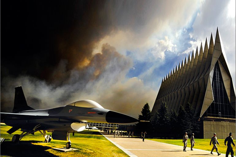 Smoke from the Waldo Canyon Fire rises near the USAF Academy's Cadet Chapel as cadets head for a briefing on evacuation procedures in this U.S. Air Force handout photo dated June 27, 2012. The Academy evacuated more than 600 families and 110 dormitory residents from the base on June 27. Photo taken June 27, 2012. REUTERS/U.S. Air Force/Carol Lawrence/Handout (UNITED STATES - Tags: MILITARY ENVIRONMENT DISASTER TPX IMAGES OF THE DAY) FOR EDITORIAL USE ONLY. NOT FOR SALE FOR MARKETING OR ADVERTISING CAMPAIGNS. THIS IMAGE HAS BEEN SUPPLIED BY A THIRD PARTY. IT IS DISTRIBUTED, EXACTLY AS RECEIVED BY REUTERS, AS A SERVICE TO CLIENTS