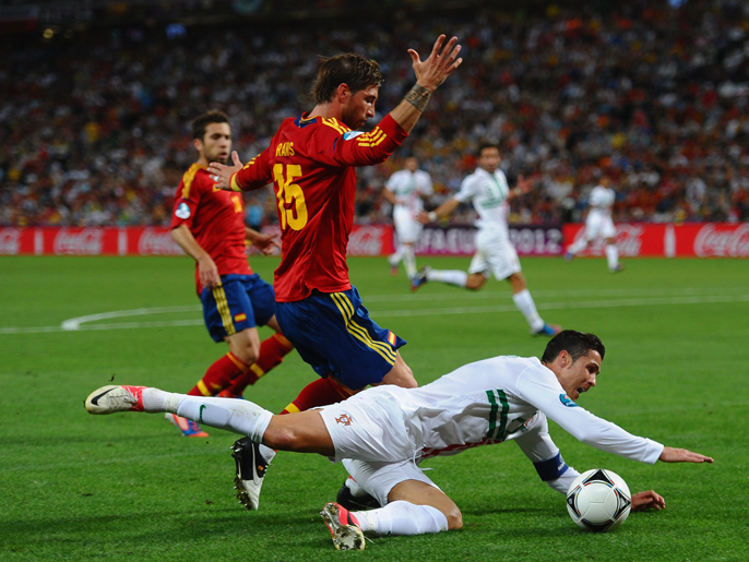 DONETSK, UKRAINE - JUNE 27:  Sergio Ramos of Spain tackles Cristiano Ronaldo of Portugal  during the UEFA EURO 2012 semi final match between Portugal and Spain at Donbass Arena on June 27, 2012 in Donetsk, Ukraine.