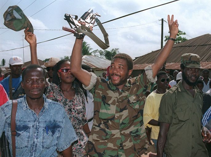 A picture taken on July 21, 1990 shows then rebel leader Charles Taylor (C) celebrating with troops in Roberts Field after taking over this position from government troops of President Samuel Doe near the Liberian capital earlier this week. Former Liberian president Charles Taylor will be sentenced for war crimes by a UN court on May 30, 2012 after being convicted for arming Sierra Leone rebels in return for "blood diamonds". Special Court for Sierra Leone judge Richard Lussick will deliver the ruling at a hearing due to start at 0900 GMT, the first sentence against a former head of state at an international court since the Nazi trials at Nuremberg in 1946. AFP PHOTO PASCAL GUYOT