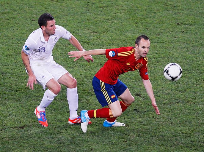 French Anthony Reveillere (L) chases Spain's Andres Iniesta during the quarter final match of the UEFA EURO 2012 between Spain and France in Donetsk, Ukraine, 23 June 2012. EPA/YURI KOCHETKOV UEFA Terms and Conditions apply