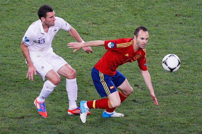 French Anthony Reveillere (L) chases Spain's Andres Iniesta during the quarter final match of the UEFA EURO 2012 between Spain and France in Donetsk, Ukraine, 23 June 2012. EPA/YURI KOCHETKOV UEFA Terms and Conditions apply
